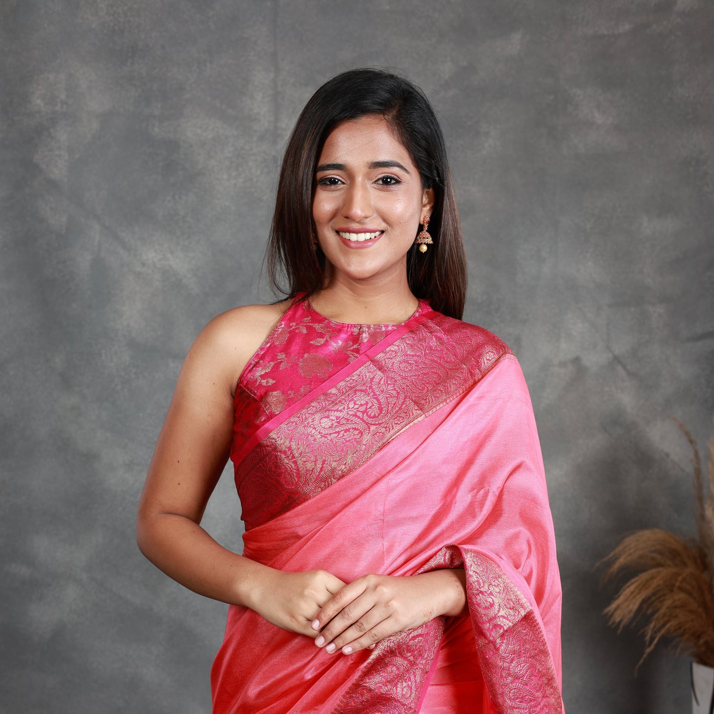 A Pink Saree adorned with a beautiful border