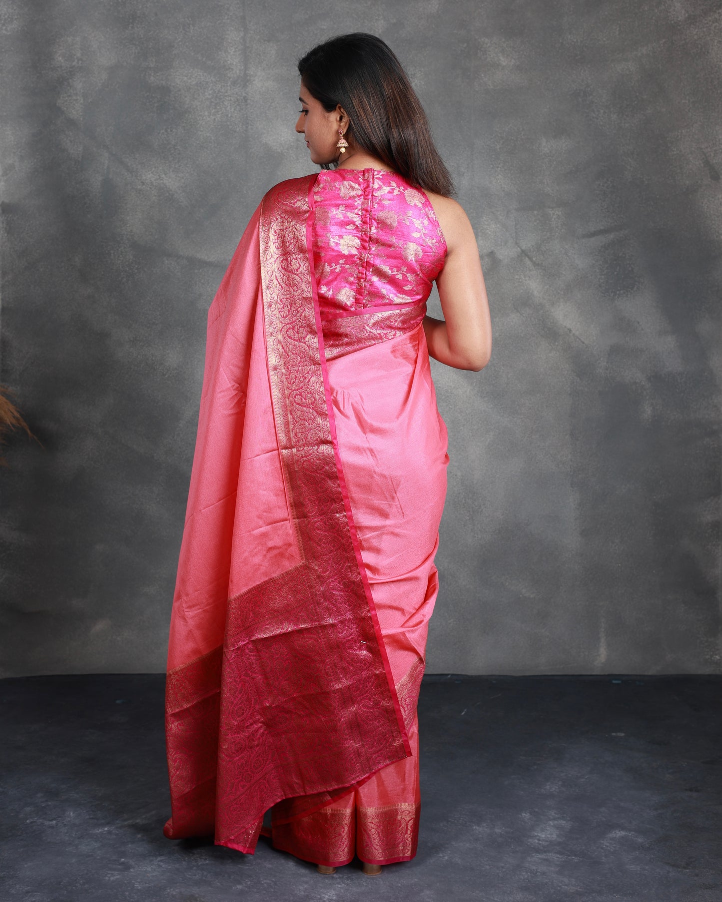 A Pink Saree adorned with a beautiful border