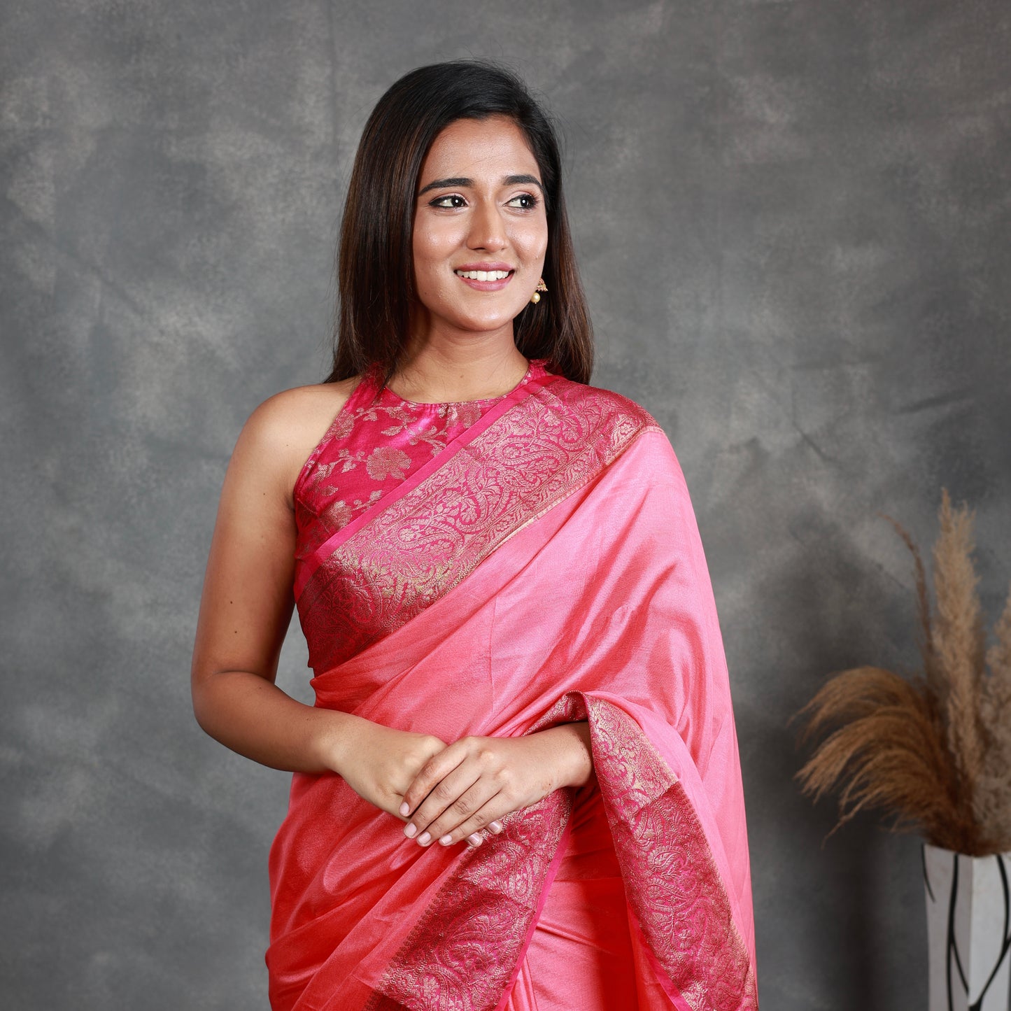 A Pink Saree adorned with a beautiful border