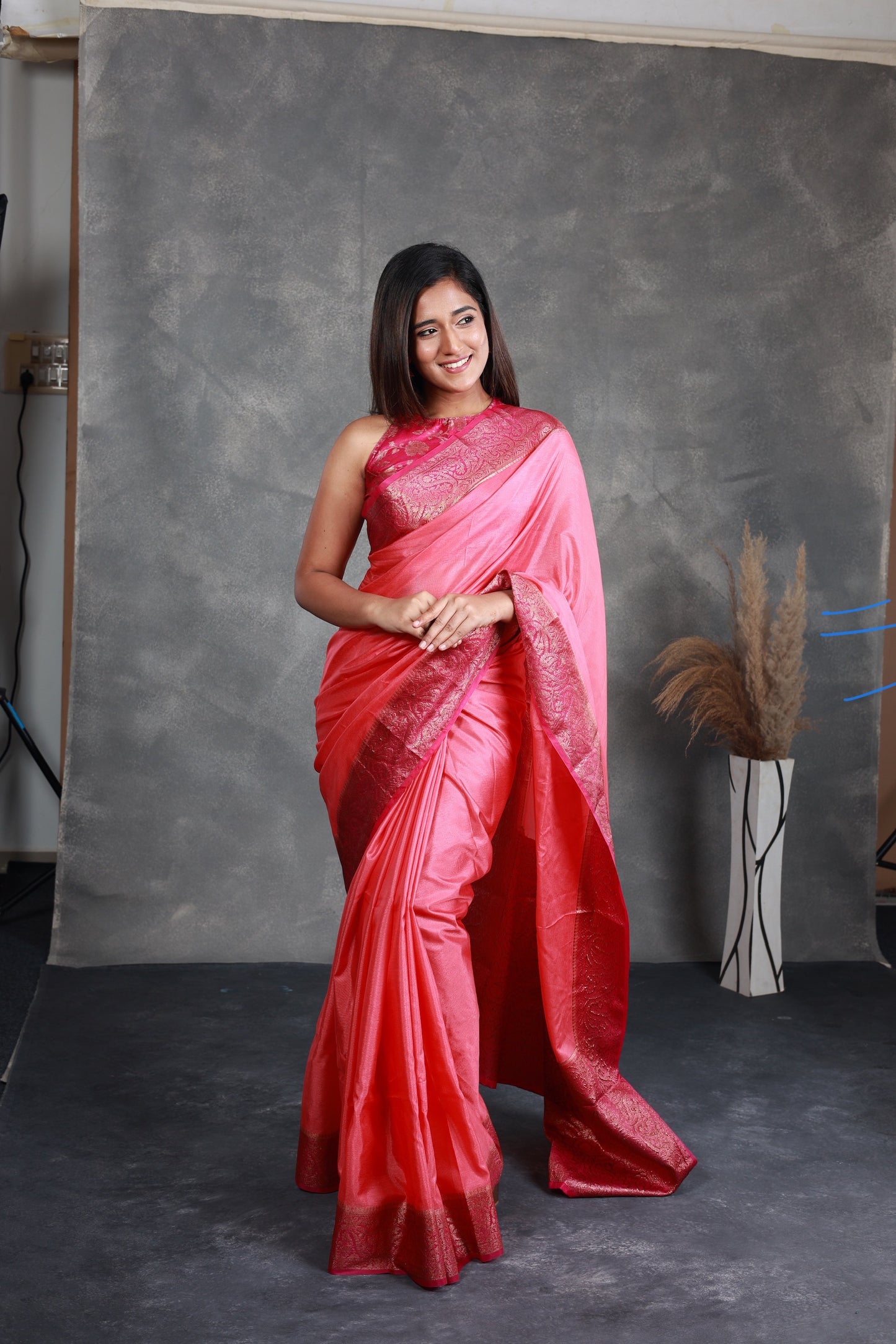 A Pink Saree adorned with a beautiful border