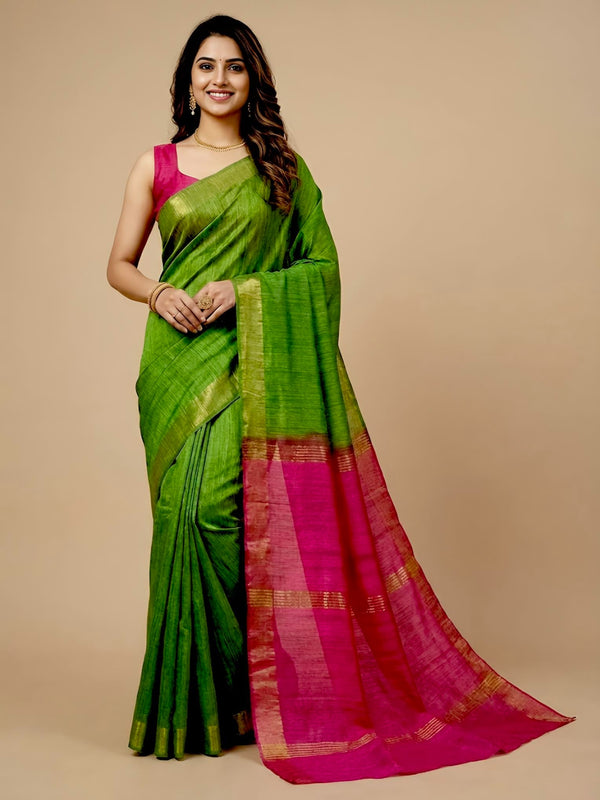 Woman wearing a green and pink saree on a beige background