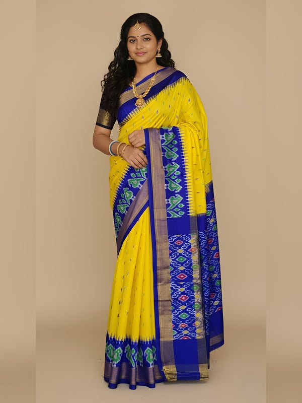 Woman wearing a yellow and blue saree with a beige background