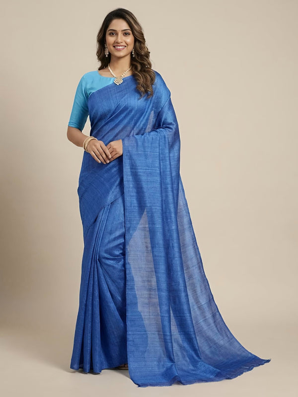 Woman wearing a blue saree with a plain background