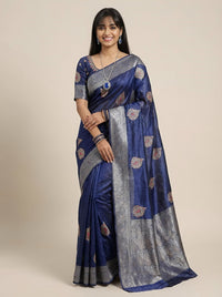 Woman wearing a blue and gray saree with a beige background