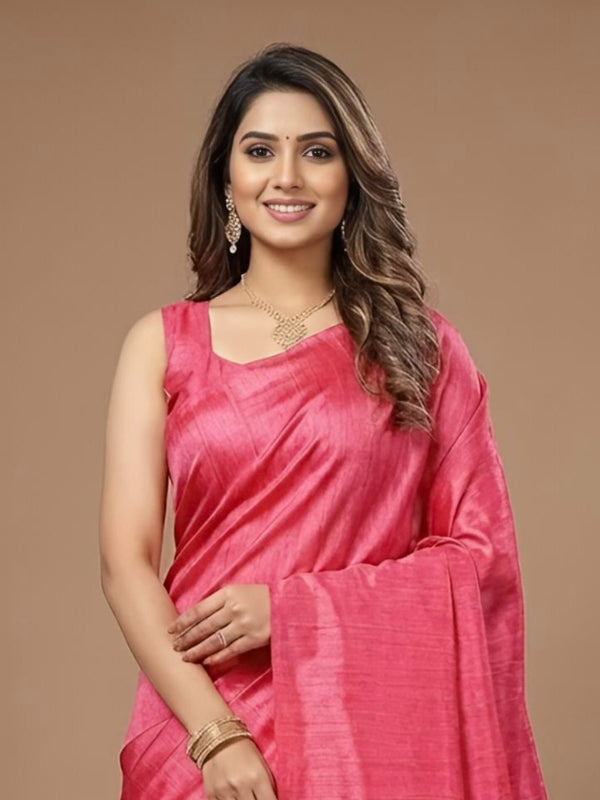 Woman wearing a pink saree on a brown background
