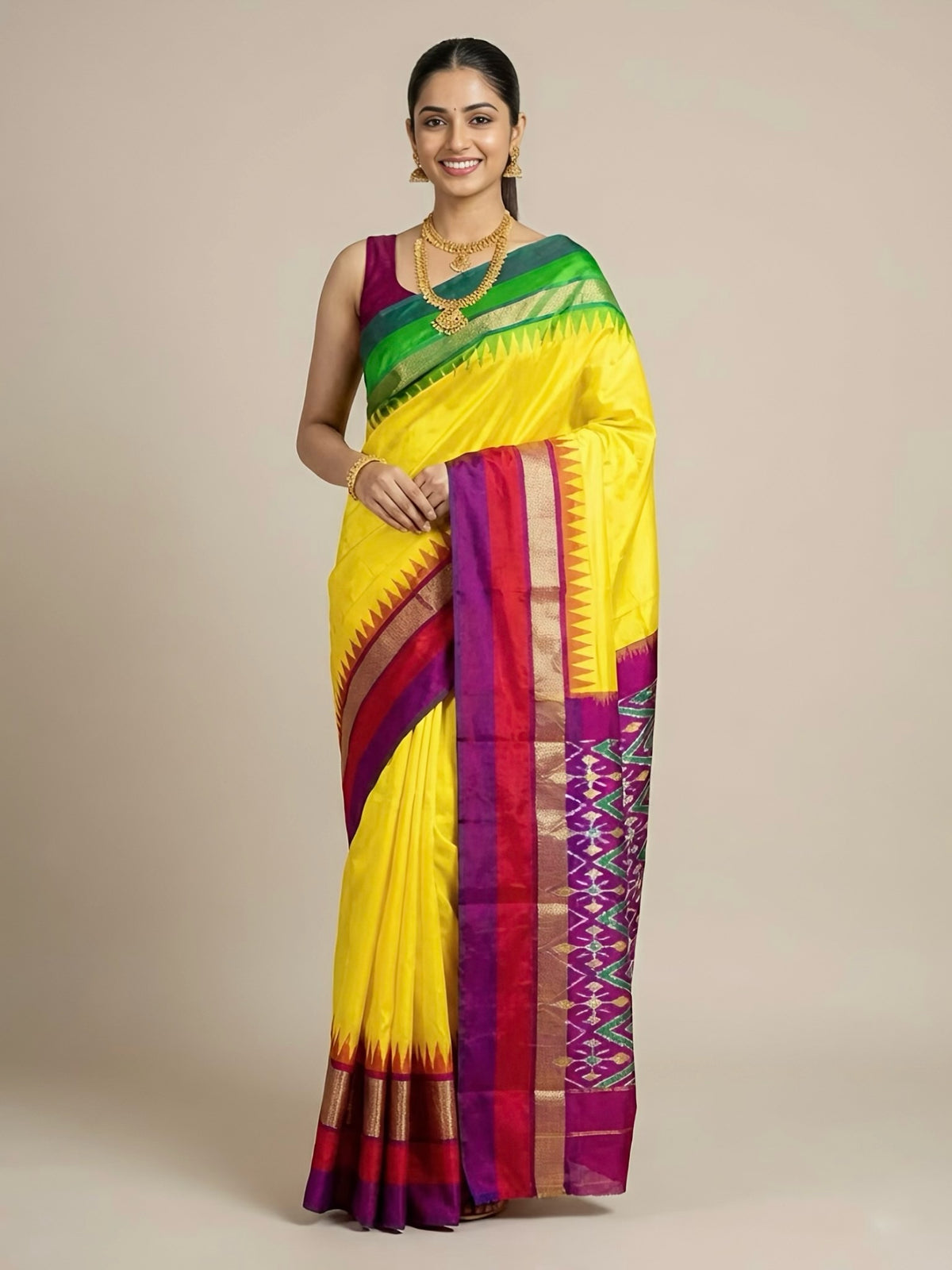 Woman wearing a yellow saree with colorful patterns on a beige background