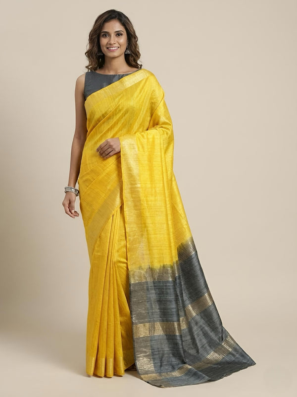 Woman wearing a yellow saree with black border on a beige background