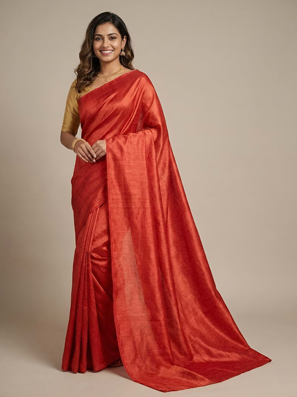 Woman wearing a red saree with a plain background